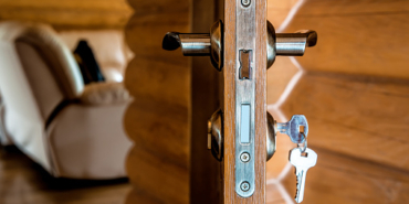 door lock with keys and opened door