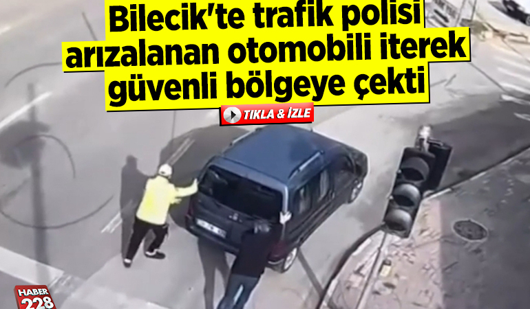 Bilecik’te trafik polisi arızalanan otomobili iterek güvenli bölgeye çekti