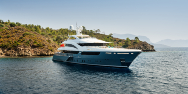 Luxury big yacht stay in the sea around the island on a background of the sky
