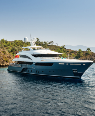 Luxury big yacht stay in the sea around the island on a background of the sky